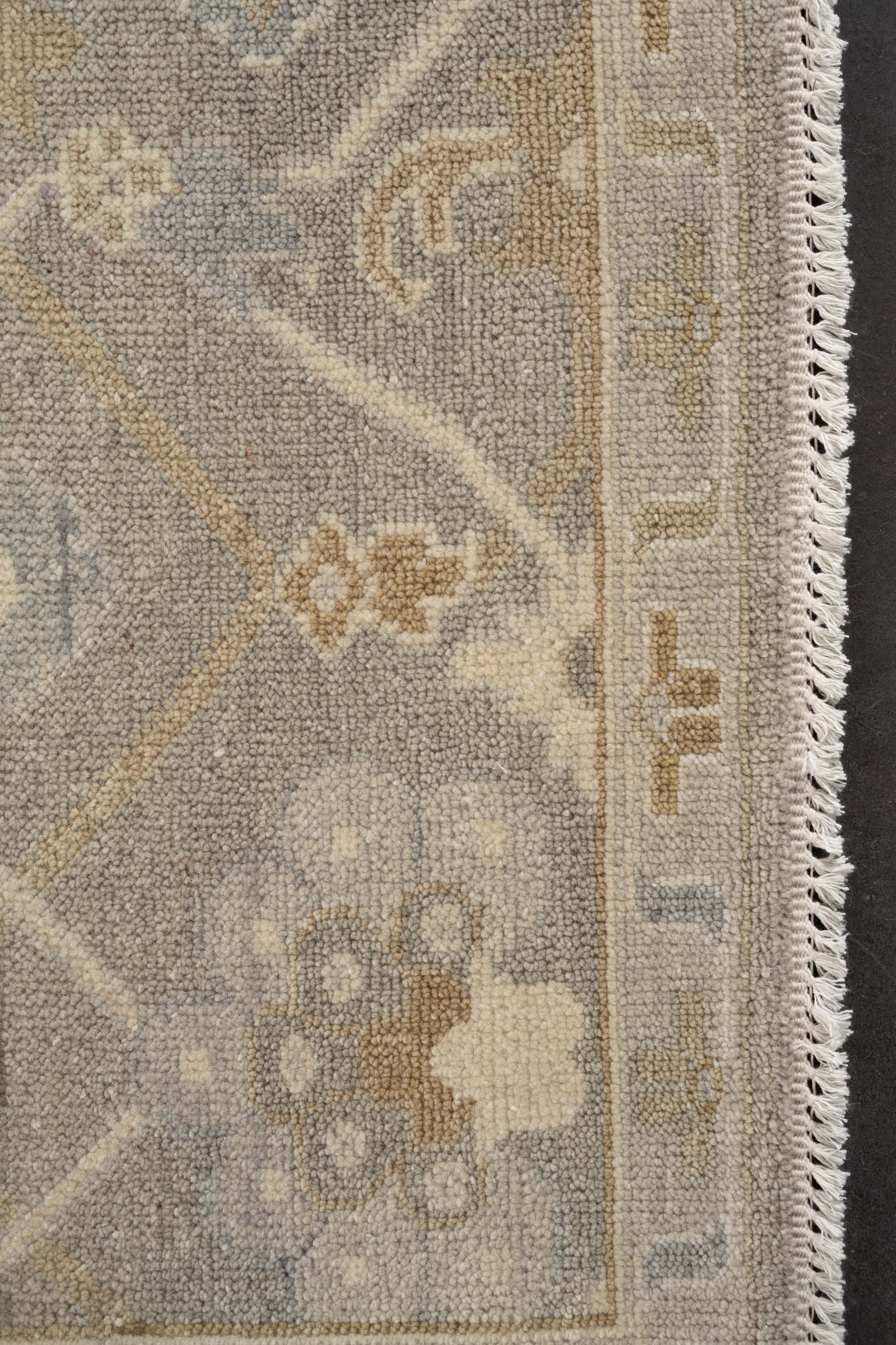 Neutral toned and hand-knotted Oushak style rug made of 100% New Zealand wool. This rug is comprised of tan, beige, ivory, and gray colors.