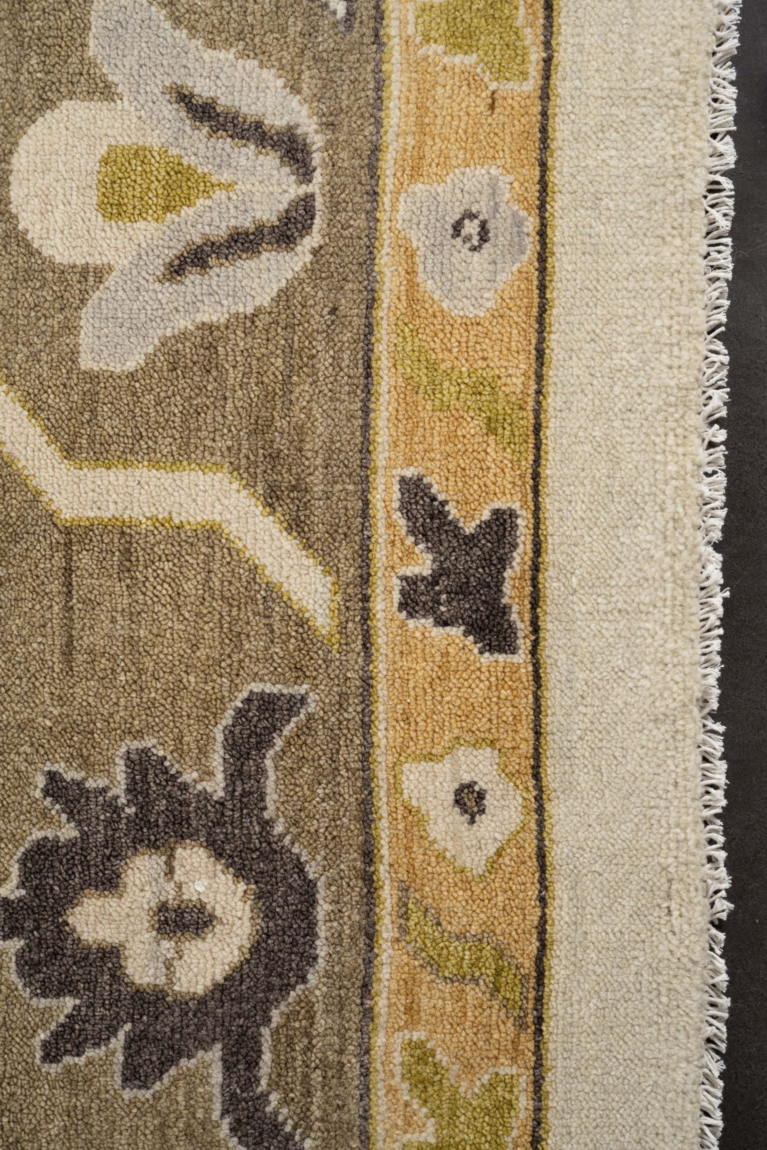 Neutral toned and hand-knotted Oushak style rug made of 100% New Zealand wool. This rug is comprised of tan, beige, brown, ivory, and charcoal colors.