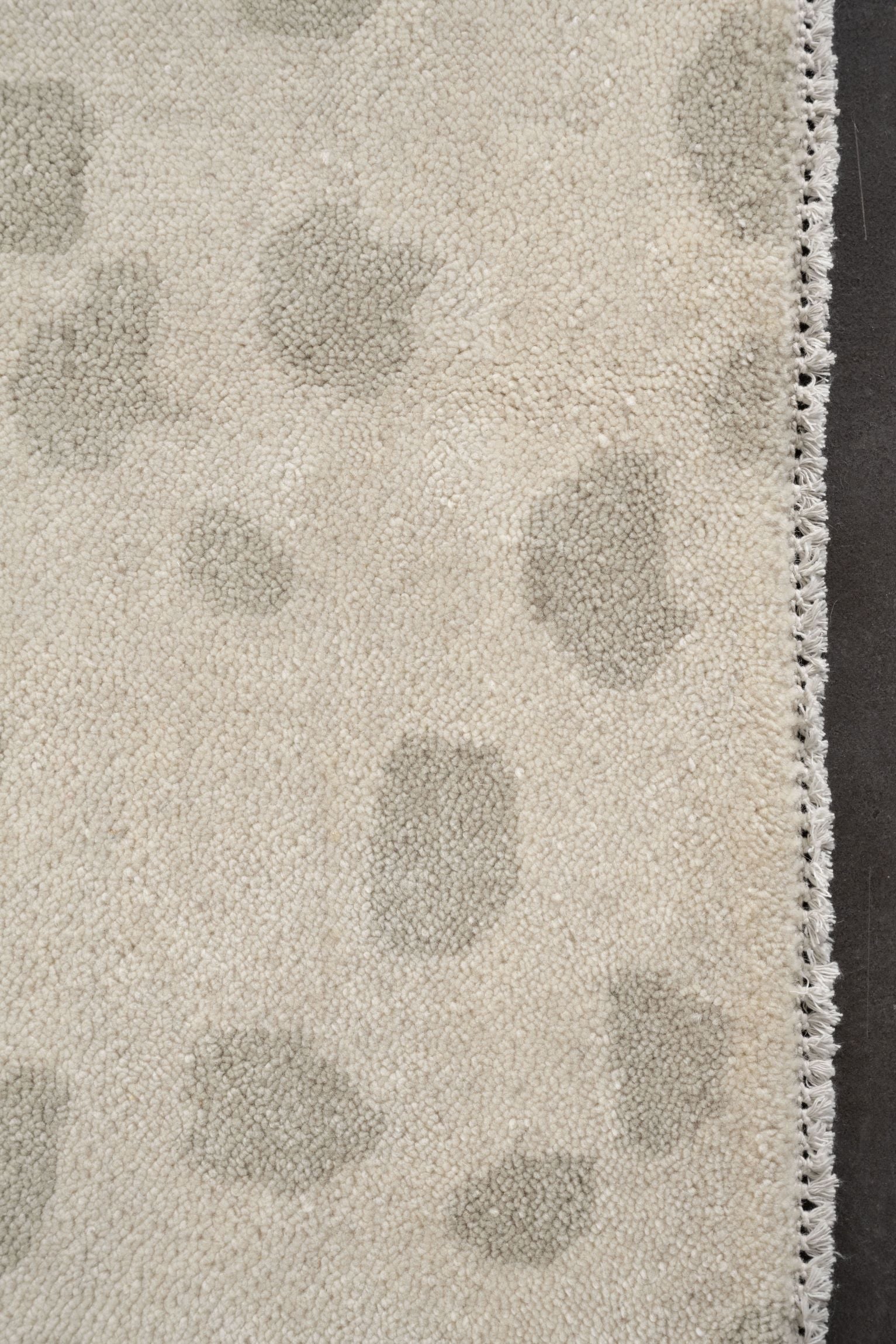 Neutral toned and hand-knotted Oushak style rug made of 100% New Zealand wool. This rug has a unique spotted pattern with beige, ivory, and gray colors.