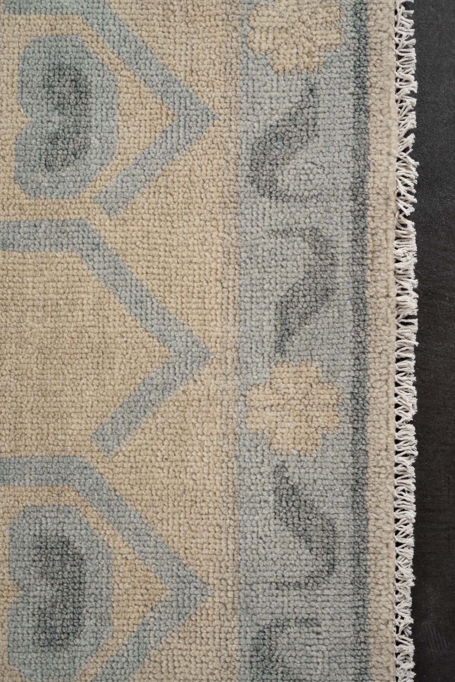 Neutral toned and hand-knotted Oushak style rug made of 100% New Zealand wool. This rug is comprised of blue, light blue, ivory, beige, charcoal, and gray colors.