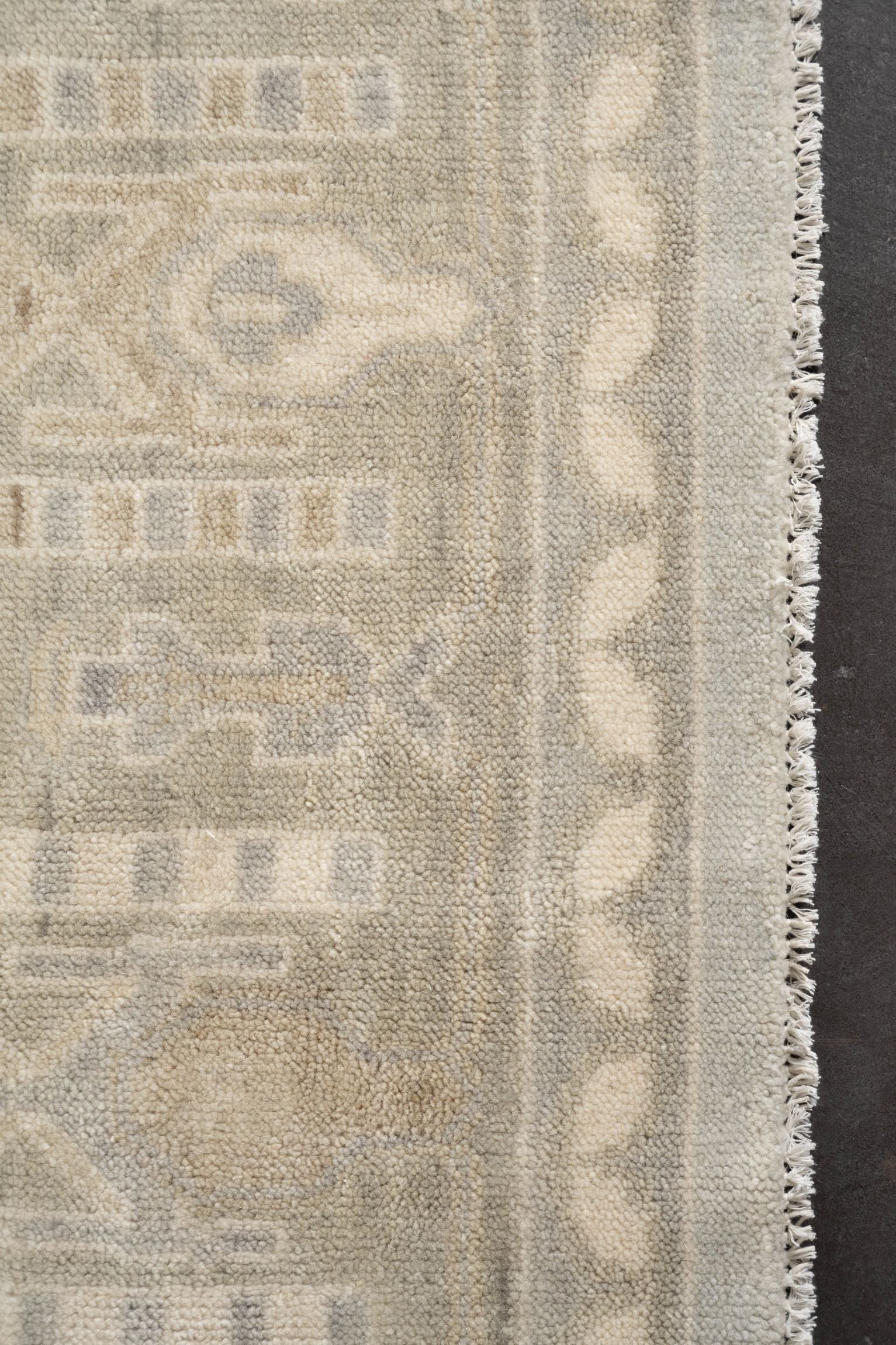 Neutral toned and hand-knotted Oushak style rug made of 100% New Zealand wool. This rug is comprised of tan, beige, brown, ivory, and gray colors.