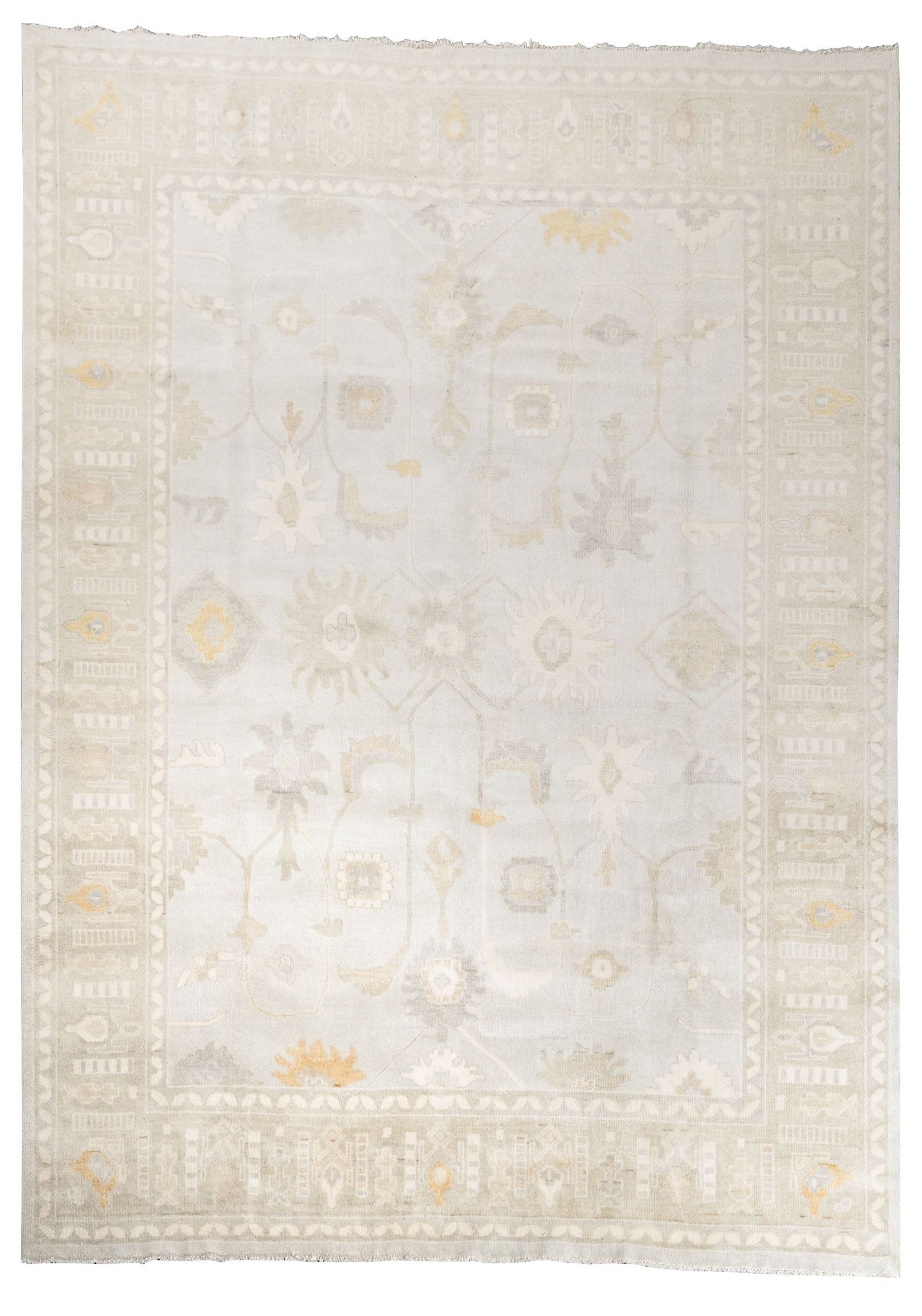 Neutral toned and hand-knotted Oushak style rug made of 100% New Zealand wool. This rug is comprised of tan, beige, brown, ivory, and gray colors.