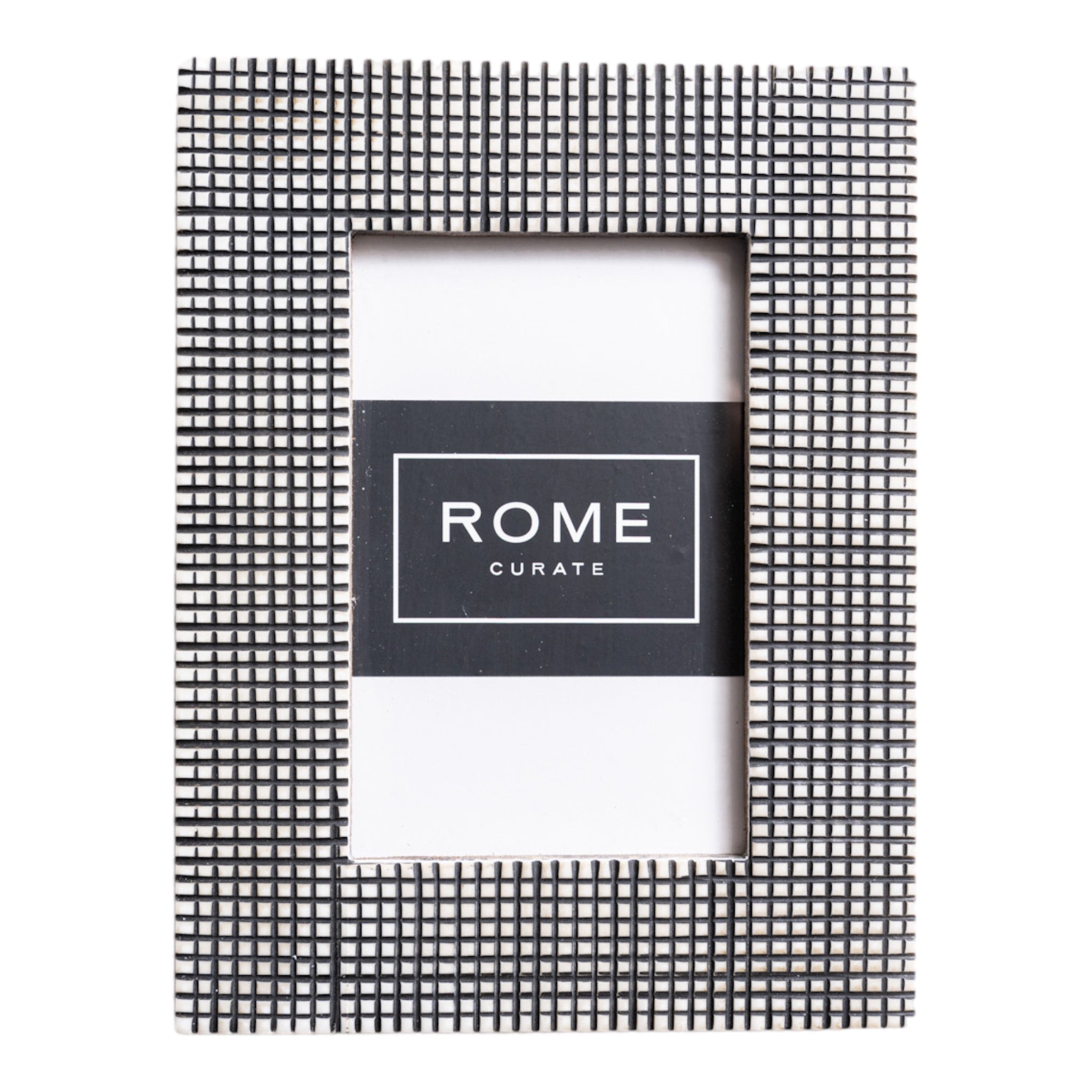 Picture frame made of bone with a carved pattern that gives a black and white dot pattern look to the frame.  