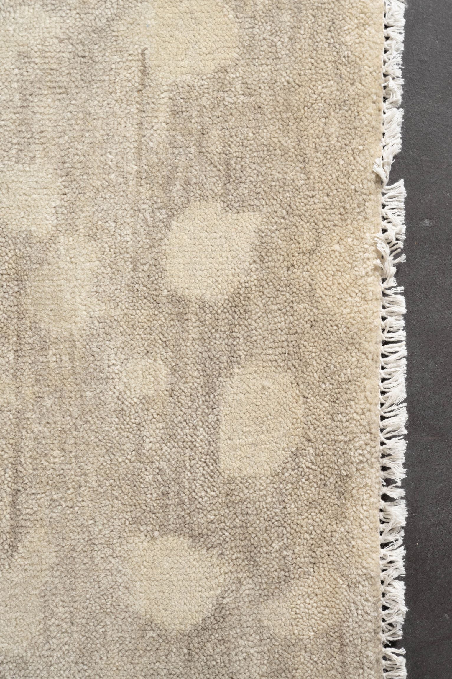 Neutral toned and hand-knotted Oushak style rug made of 100% New Zealand wool. This rug has a unique spotted pattern with tan, taupe, beige, ivory, and brown colors.